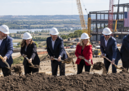 Editorial illustration of an Iowa casino construction groundbreaking with cranes and a state map